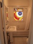 Tile bath with original stained glass window and vintage look/feel.