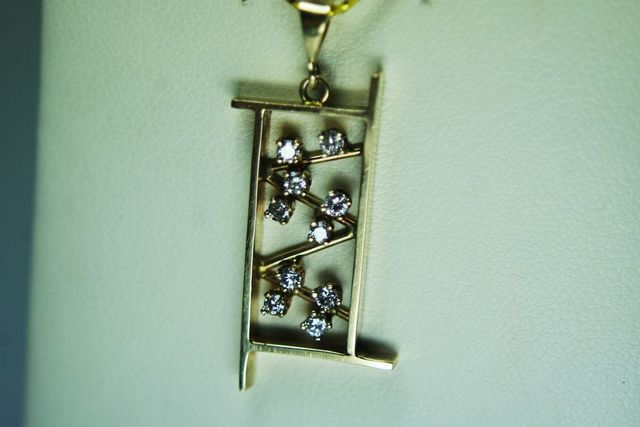 Ladies Yellow Gold Shadow Box Design Pendant with .28ct total round diamonds.